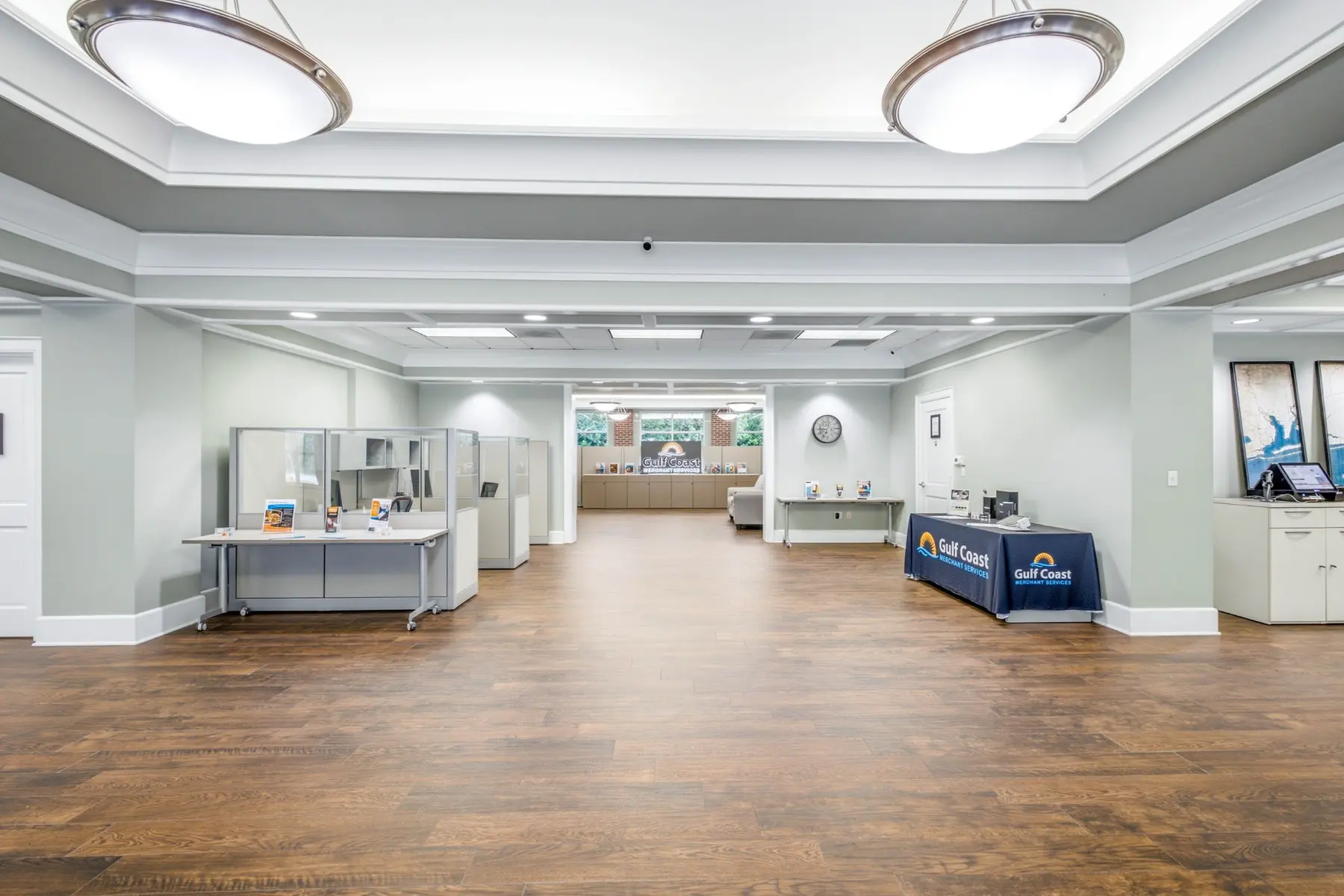 Open work area inside Cadenhead Legacy Center, with a Gulf Coast Merchant Services display